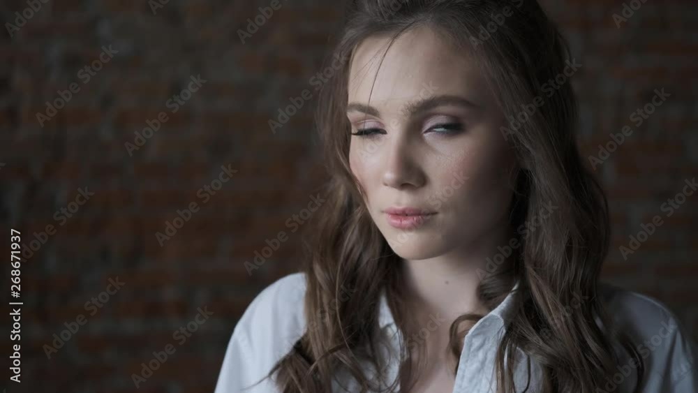 Portrait of an attractive girl in a white blouse close-up. beautiful blue-eyed model looking into the camera. Portrait of an attractive girl in a white blouse close-up. beautiful blue-eyed model looking into the camera.