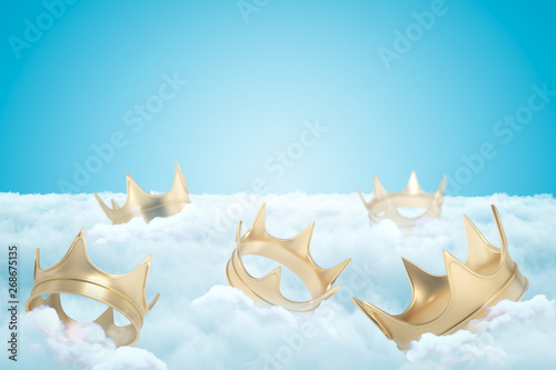 фотографія 3d rendering of set of gold crowns on thick layer of white fluffy clouds with blue sky above
