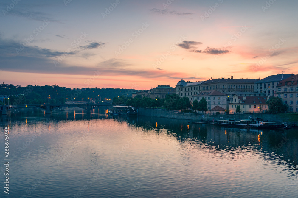 Sunrise in Prague. Historic waterfront architecture and Vltava river