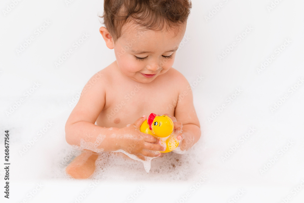 Baby boy in bubble bath with rubber duck Baby boy in bubble bath with rubber duck