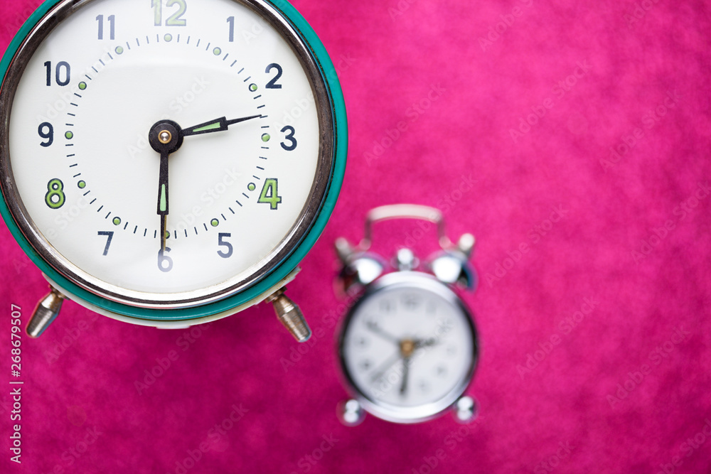 Retro alarm clock on pink abstract background Retro alarm clock on pink abstract background