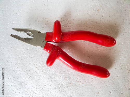 Pliers with red handles on a white background. View from the top. Insulated.