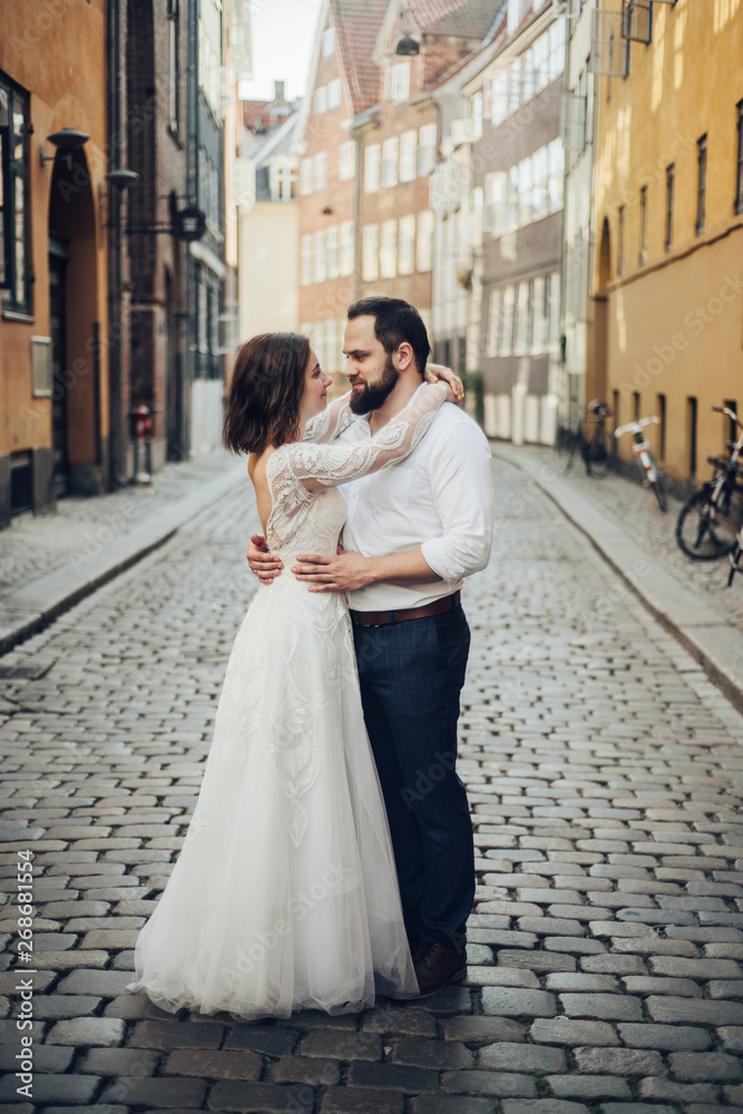 Happy to be together. Lovely wedding tourist couple walking on the city street. Happy to be together. Lovely wedding tourist couple walking on the city street.