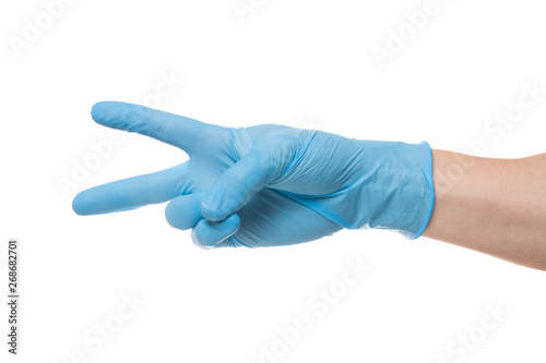 Right hand wearing latex surgical glove with gesture number two on wite background.