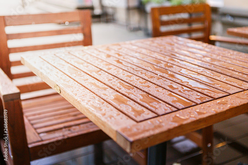 Table in a summer cafe after the rain. Raindrops on the table.
