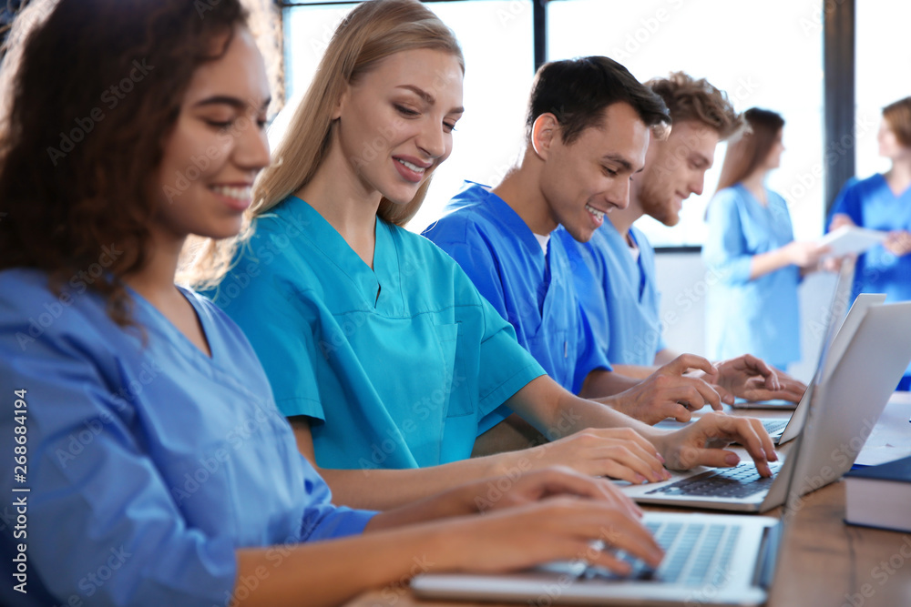 Fototapeta premium Group of smart medical students with gadgets in college