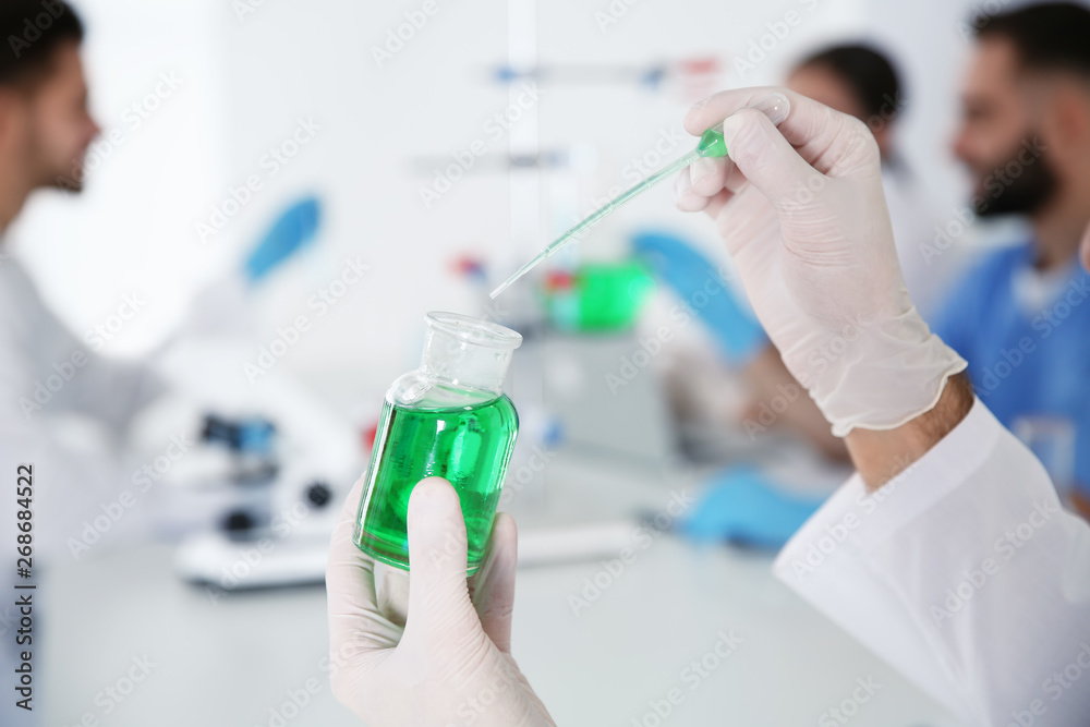 Medical student working in modern scientific laboratory, closeup Medical student working in modern scientific laboratory, closeup