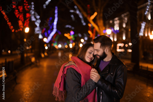 Lovely couple spending time in city at night