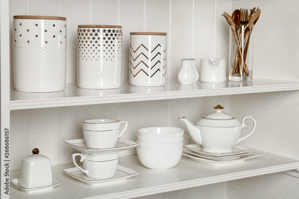 White shelving unit with set of dishware White shelving unit with set of dishware