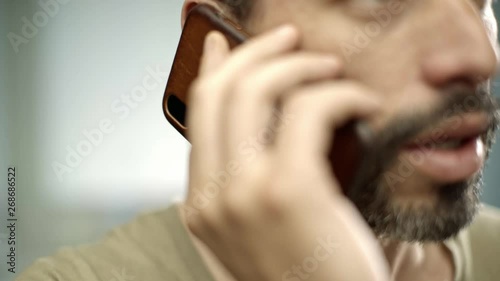 Wallpaper Mural close up of a handsome caucasian man texting and smiling in his kitchen  Torontodigital.ca