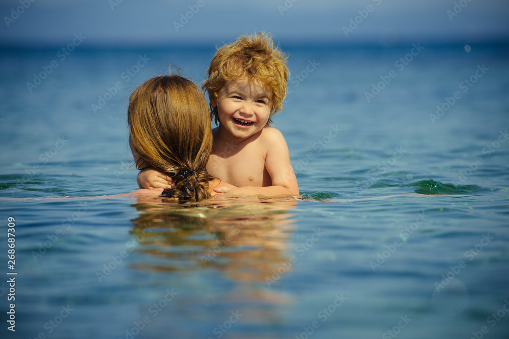 Happy vacation. Summer mood. Mother and soon in the sea.