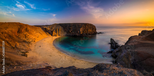 Romantic sunset over the beautiful, natural and sandy beach of Papagayo on Lanzarote photo