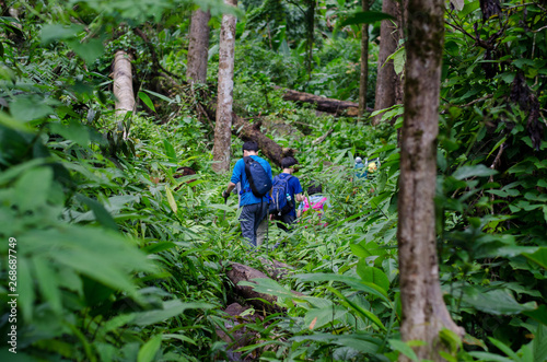Father and son are trekking in Phu Soi Dao National Park, Thailand.