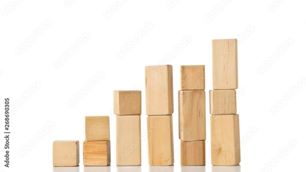 Wooden block building pieces forming steps in stop motion - career, growth or development concept Wooden block building pieces forming steps in stop motion - career, growth or development concept