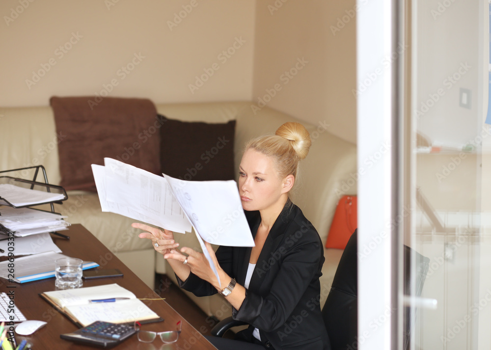A middle aged woman working in her office A middle aged woman working in her office