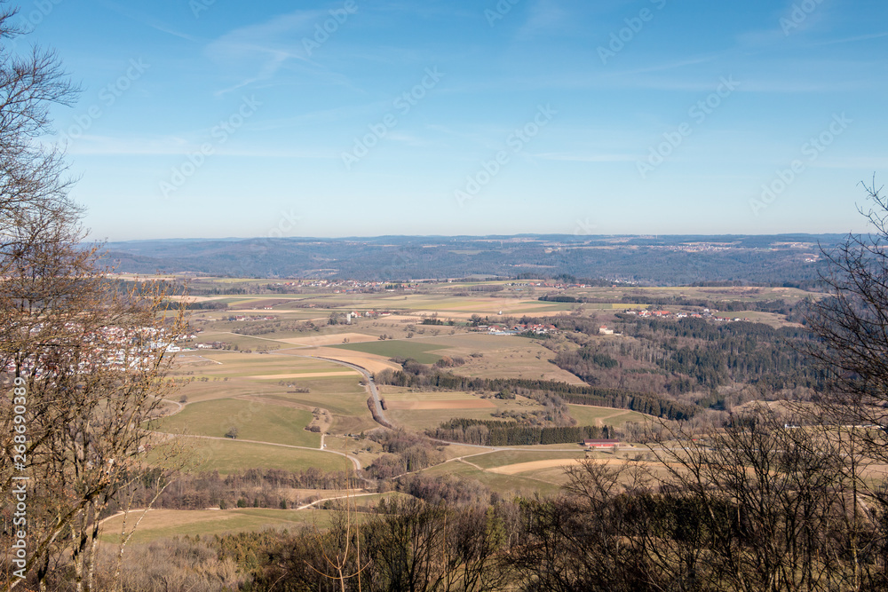 Fototapeta premium Little village in the middle of the german countryside with hills, forests, fields and meadows