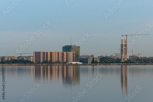 High Buildings Beautifully Reflected into Water in the Evening