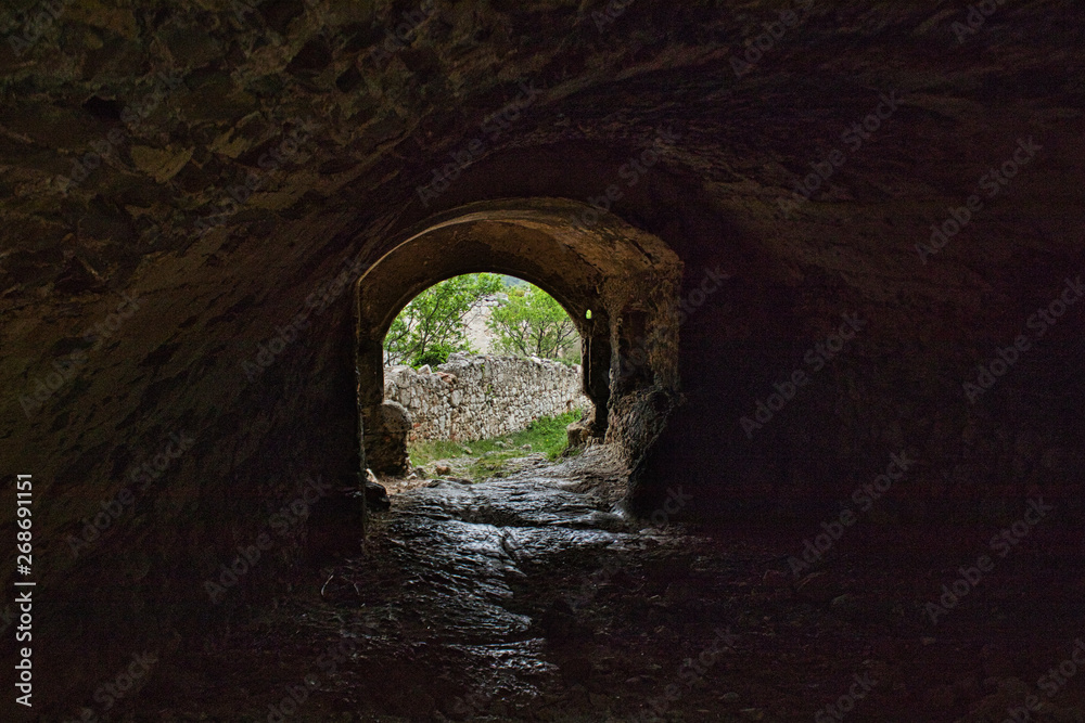 a tunnel in an old castle ruin