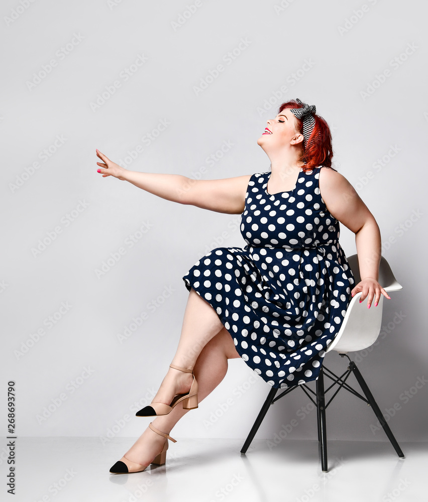 Pin up a female portrait. Beautiful retro fat woman in polka dot dress with  red lips and old-style haircut Stock Photo | Adobe Stock