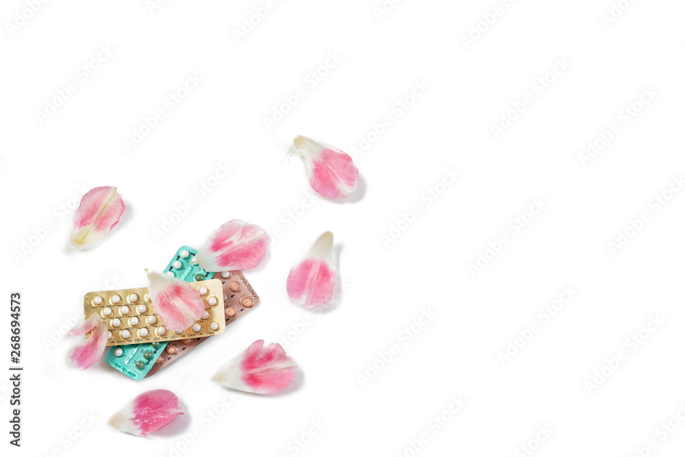 Oral contraceptive pills. Birth control pills.Contraceptive Pill and Flowers Rose petals on white Background.