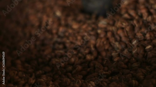 Seamless mixing roasted coffee. Cooling down freshly roasted coffee beans