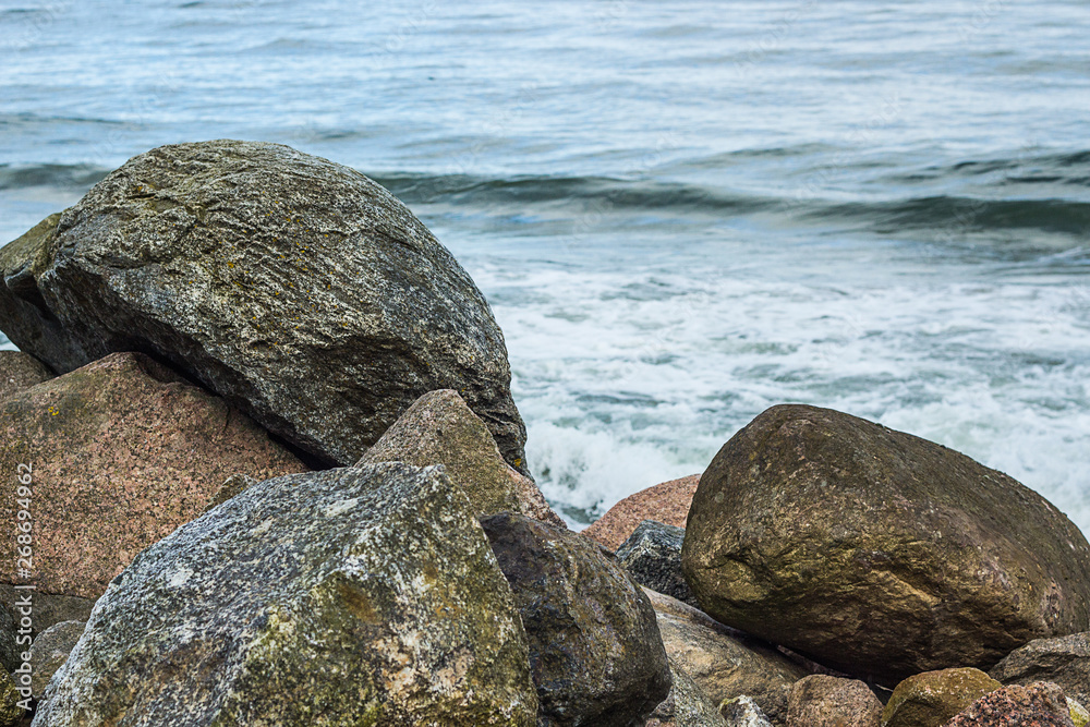 several small and big white and gray stones or pebbles on the beach at the baltic sea, a great pattern for a background several small and big white and gray stones or pebbles on the beach at the baltic sea, a great pattern for a background