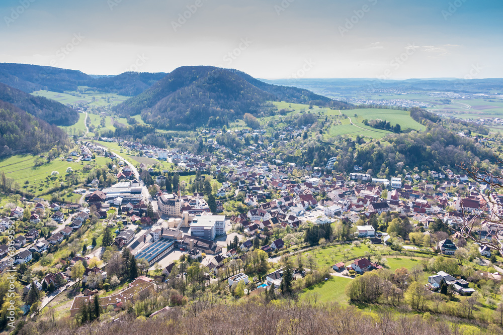 Little village in the middle of the german countryside with hills, forests, fields and meadows