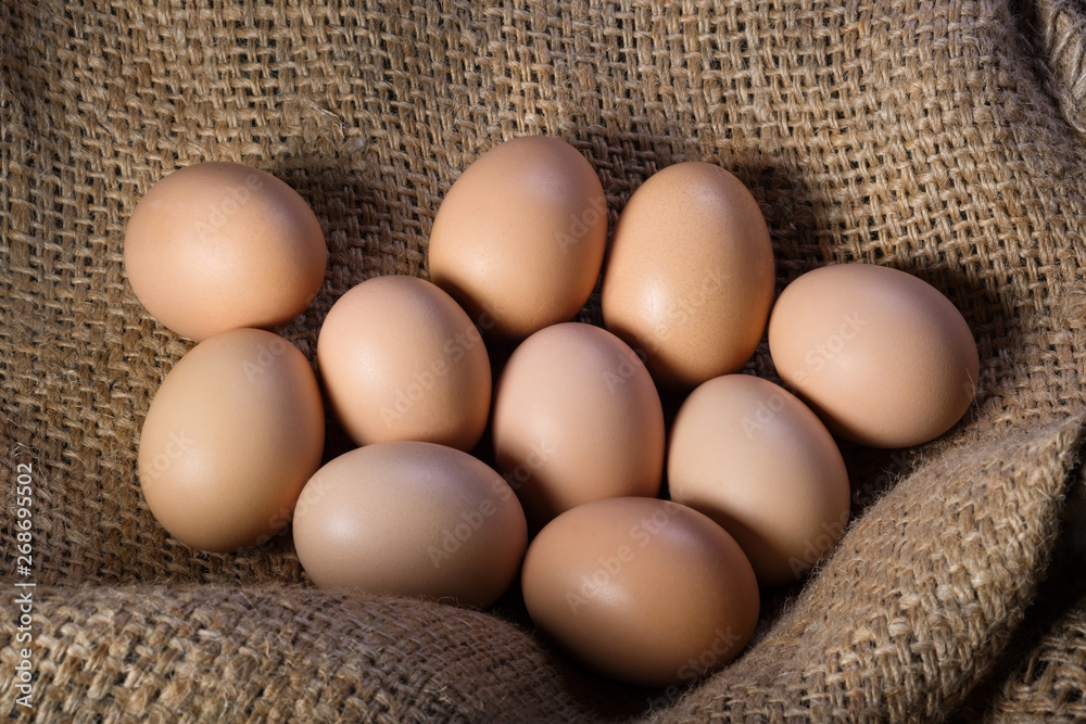 Fresh eggs on burlap close up. Natural protein, poultry farm Fresh eggs on burlap close up. Natural protein, poultry farm