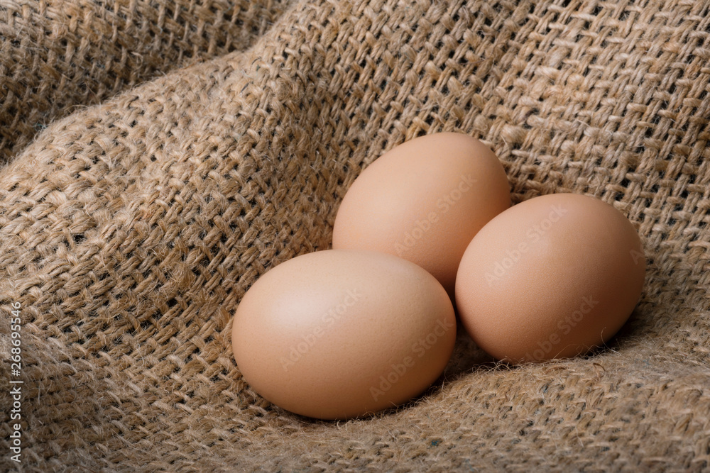 Fresh brown eggs on a bag. Natural crude products. Fresh brown eggs on a bag. Natural crude products.