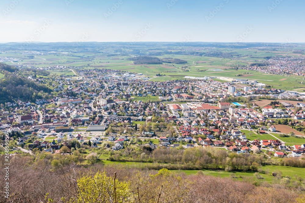 Little village in the middle of the german countryside with hills, forests, fields and meadows