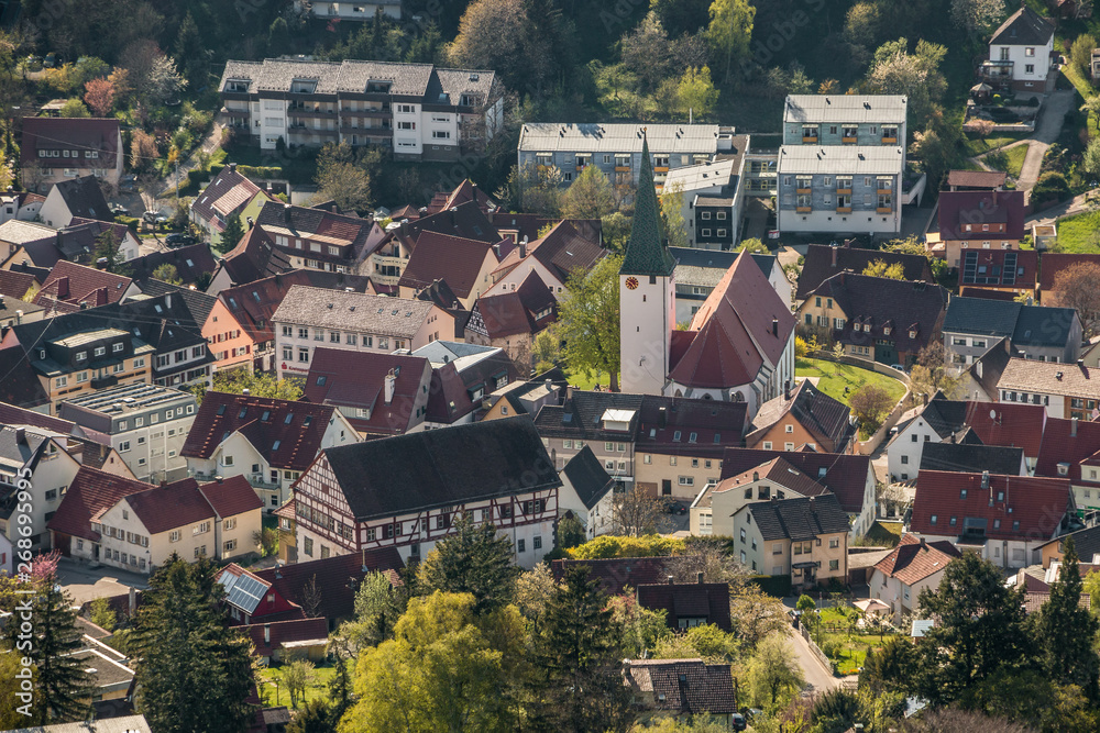 Little village in the middle of the german countryside with a church and half-timber houses and green trees