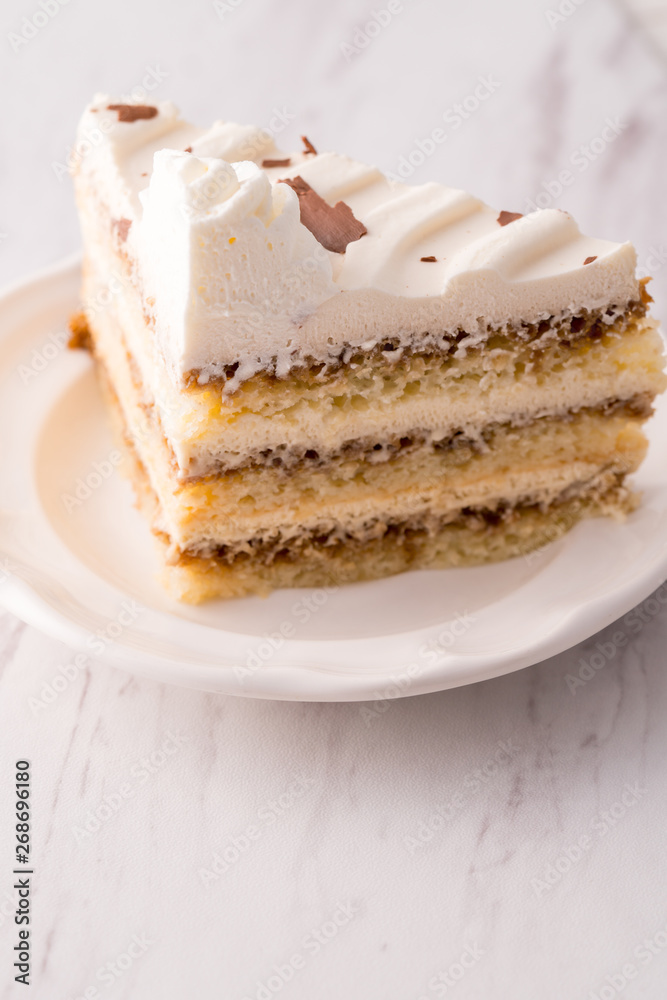 Tiramisu cake slice with white frosting Tiramisu cake slice with white frosting