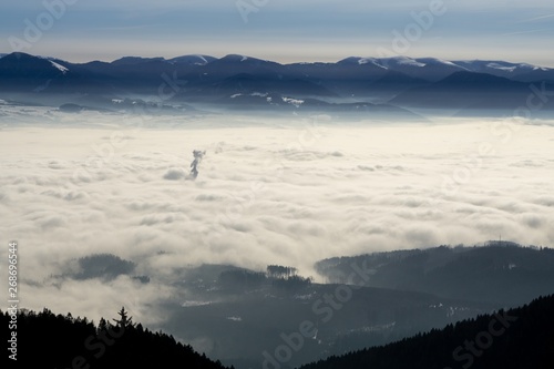 Clouds inversion in the town during autumn morning from mountains. Slovakia photo