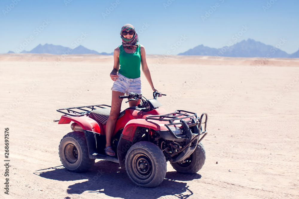 A group of quad bikes drive in the desert A group of quad bikes drive in the desert