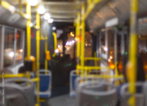 blurred photo, the bus is released in the evening, people rush home
