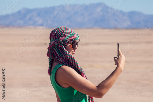 Woman makes selfie in the desert of Egypt. People and travel concept photo