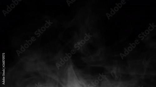 Wispy, swirling smoke / vapor on black background for compositing. Smoke enters from bottom frame and floats up / dissipates