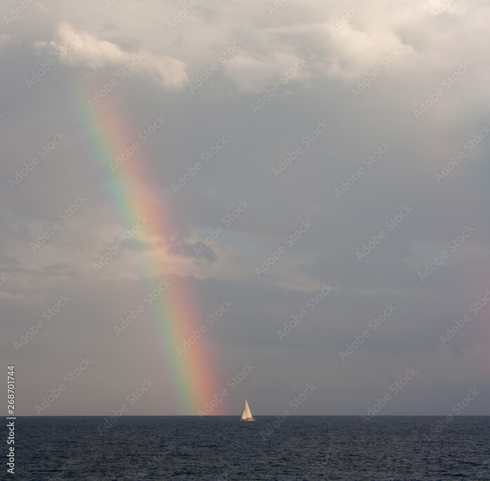 A boat at the sea and a rainbow above the sea in Sydney