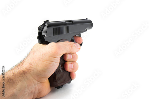 Hand holds a gun isolated on white background