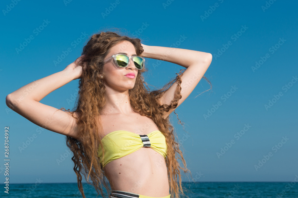 Naklejka premium Beautiful woman in bikini in summer near the sea