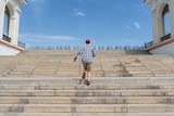 urban concept, young man walk on the stairs in the city