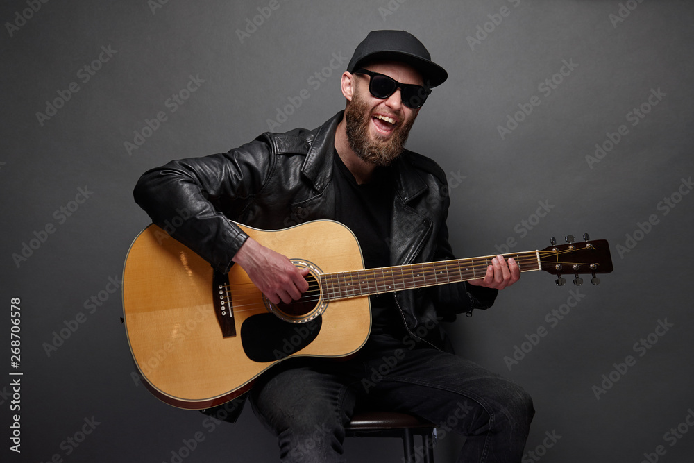 Guitar player with beard and black clothes Guitar player with beard and black clothes