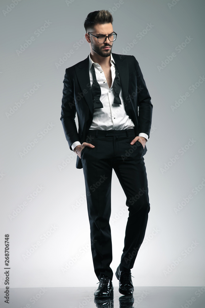 Charming guy stepping and curiously looking to the side Charming guy stepping and curiously looking to the side