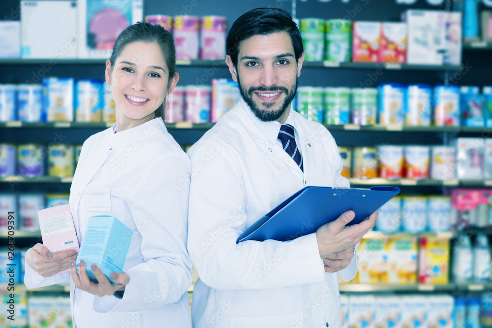 pharmacist and expert standing near shelves with medicines