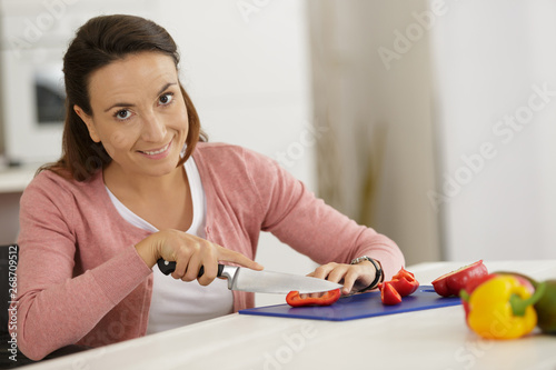 happy woman female cuts asunder red tomatos photo