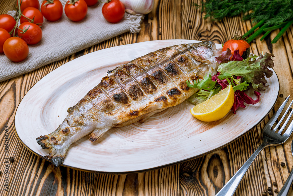 trout grilled on wooden background trout grilled on wooden background