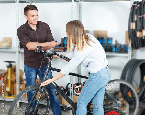 Male and female are pumping bicycle wheels