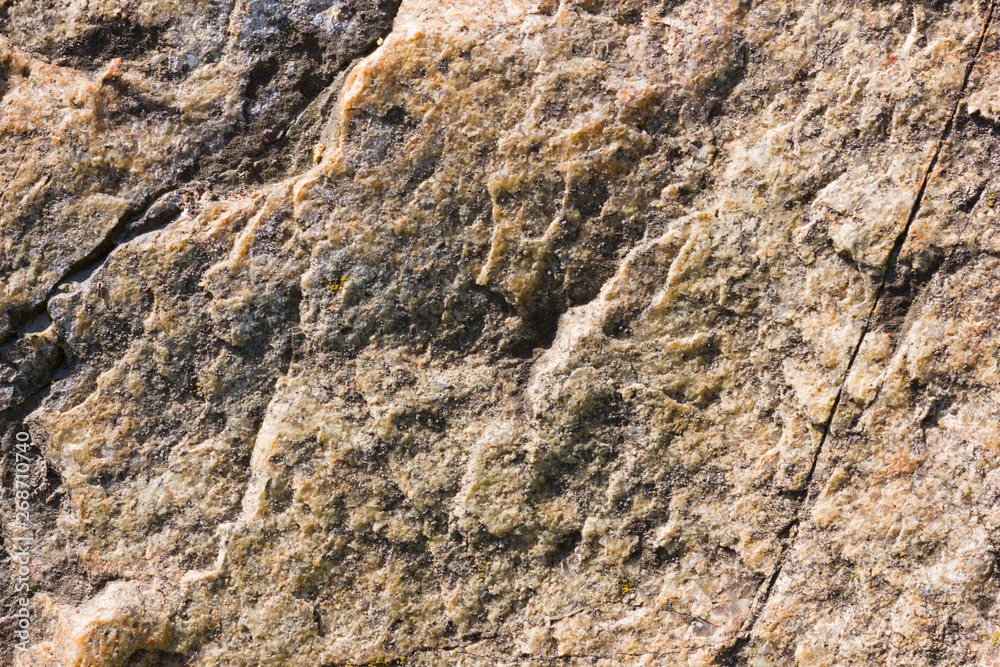 Background of granite. Texture of granite stone. Pattern of roughened surface. Texture of brown stone Background of granite. Texture of granite stone. Pattern of roughened surface. Texture of brown stone