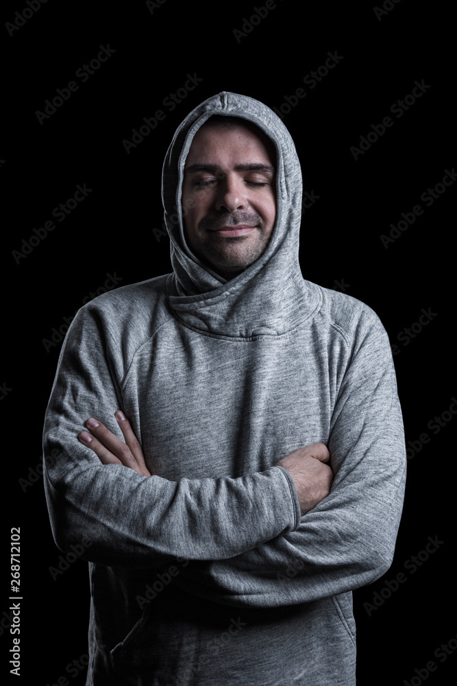 Studio portrait of a man with closed eyes and arms crossed. Isolated on black background. Vertical. Studio portrait of a man with closed eyes and arms crossed. Isolated on black background. Vertical.