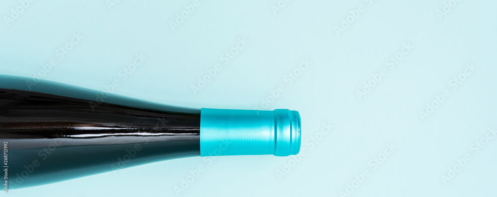 Colorful bottle caps of white and rose wine bottles on turquoise background. Minimal abstract colorful layout concept of summer time alcohol beverage. Long wide banner. Colorful bottle caps of white and rose wine bottles on turquoise background. Minimal abstract colorful layout concept of summer time alcohol beverage. Long wide banner.